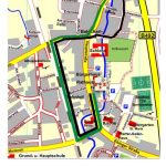 Stadtplan mit markierter Umzugsroute (schwarz/grün) rund um Schloss, Rathaus und Bahnhof; Text: Umzug startet um 14:00 Uhr.